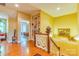 Bright foyer featuring wood floors, a staircase, a display shelf, and a glimpse of a bedroom at 3400 Baucom Manor Rd, Monroe, NC 28110