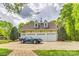 Three car garage featuring a vintage blue convertible parked on the large driveway in front at 3400 Baucom Manor Rd, Monroe, NC 28110