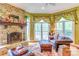 Inviting living room showcasing a stone fireplace, large windows, and cozy seating at 3400 Baucom Manor Rd, Monroe, NC 28110