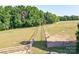 Expansive fenced pastureland featuring green grass and mature trees perfect for raising horses and livestock at 3400 Baucom Manor Rd, Monroe, NC 28110