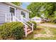 A charming single story home with grey siding and white trim, complemented by lush greenery and a detached building at 444 Oakwood Ave, Mooresville, NC 28115