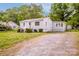 The home has a gravel driveway, and a fenced yard. Also features updated windows and exterior lighting at 444 Oakwood Ave, Mooresville, NC 28115