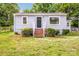 Quaint single-story home featuring gray siding, brick stairs, and well-maintained landscaping at 444 Oakwood Ave, Mooresville, NC 28115