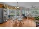 Breakfast nook with chandelier, large windows, and views of the wooded backyard at 4563 Osprey Run Ct, Denver, NC 28037
