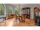Elegant dining room with hardwood floors, large windows, and a classic chandelier at 4563 Osprey Run Ct, Denver, NC 28037