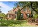 Charming brick home featuring a lush lawn, mature trees, and elegant architectural details at 4563 Osprey Run Ct, Denver, NC 28037