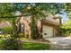 Charming brick home exterior featuring a side-entry garage, manicured lawn, and mature trees at 4563 Osprey Run Ct, Denver, NC 28037