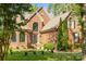 Elegant brick facade showcasing arched windows and mature landscaping at 4563 Osprey Run Ct, Denver, NC 28037