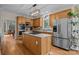 Kitchen with island cooktop, stainless steel appliances, and wood cabinets at 4563 Osprey Run Ct, Denver, NC 28037
