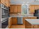 Kitchen featuring stainless steel appliances, wood cabinets, and large windows at 4563 Osprey Run Ct, Denver, NC 28037
