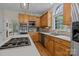 Kitchen with stainless steel appliances, wood cabinets, and island cooktop at 4563 Osprey Run Ct, Denver, NC 28037