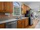 Kitchen with stainless steel appliances, wood cabinets, and a window over the sink at 4563 Osprey Run Ct, Denver, NC 28037