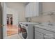 Functional laundry room with modern washer/dryer, utility sink, and ample cabinet space, convenient for household tasks at 4563 Osprey Run Ct, Denver, NC 28037