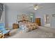 Large primary bedroom with sitting area, floral bedding, and bright natural light at 4563 Osprey Run Ct, Denver, NC 28037