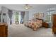 Spacious primary bedroom with sitting area, floral bedding, and bright natural light at 4563 Osprey Run Ct, Denver, NC 28037