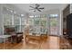 Sun room with hardwood floors, ceiling fan, and large windows with wooded backyard views at 4563 Osprey Run Ct, Denver, NC 28037