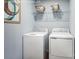 Functional laundry room featuring a white washer and dryer with shelving above at 5224 Mccallum Meadows Dr, Charlotte, NC 28216