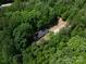 An aerial view showing the house and property, highlighting its location within a lush, green landscape at 5376 Walter Estate Ln, Iron Station, NC 28080