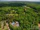 A lovely aerial view shows the property is surrounded by a lush green forest at 5376 Walter Estate Ln, Iron Station, NC 28080
