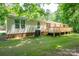 Exterior of house featuring a large backyard with a wooden deck and well-maintained lawn at 5376 Walter Estate Ln, Iron Station, NC 28080