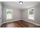 This bedroom boasts wood floors, natural light, and neutral paint at 5376 Walter Estate Ln, Iron Station, NC 28080