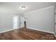 This bedroom boasts wood floors, neutral walls, with natural light and white doors at 5376 Walter Estate Ln, Iron Station, NC 28080
