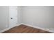 This bedroom features wood floors, neutral walls, and a white door at 5376 Walter Estate Ln, Iron Station, NC 28080