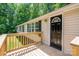 Home exterior features a light-colored exterior with a black front door and a wooden deck at 5376 Walter Estate Ln, Iron Station, NC 28080