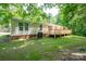 Exterior of home showing backyard and wooden deck with access stairs at 5376 Walter Estate Ln, Iron Station, NC 28080