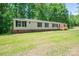 Exterior view of home with mature trees and a green lawn at 5376 Walter Estate Ln, Iron Station, NC 28080