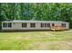 Charming home exterior with brick base, black shutters, and a new wooden porch at 5376 Walter Estate Ln, Iron Station, NC 28080