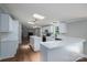 Kitchen boasts white cabinets, quartz counters, stainless appliances, an island, and two skylights at 5376 Walter Estate Ln, Iron Station, NC 28080