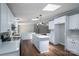 Kitchen features white cabinets, quartz counters, stainless appliances and a center island with seating at 5376 Walter Estate Ln, Iron Station, NC 28080