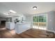 Open kitchen boasts white cabinets, a center island, skylights and sliding glass doors to the deck at 5376 Walter Estate Ln, Iron Station, NC 28080