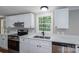 Bright kitchen featuring white cabinets, quartz counters, stainless appliances, and a window at 5376 Walter Estate Ln, Iron Station, NC 28080