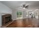 Cozy living room featuring wood-look floors, stone fireplace, and sliding door access to the deck at 5376 Walter Estate Ln, Iron Station, NC 28080