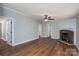 Open living room features wood-look floors and a stone fireplace at 5376 Walter Estate Ln, Iron Station, NC 28080