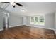 Spacious living room with wood floors and large windows for natural light, creating an inviting atmosphere at 5376 Walter Estate Ln, Iron Station, NC 28080