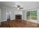 Living room featuring wood-look flooring, a stone fireplace and a sliding door to the backyard at 5376 Walter Estate Ln, Iron Station, NC 28080