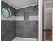 Updated walk-in shower features decorative tilework and a niche for storage at 5376 Walter Estate Ln, Iron Station, NC 28080
