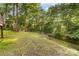 View of yard backed by mature trees at 552 Blue Rock Dr, Charlotte, NC 28213