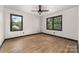 Bright bedroom features hardwood floors, multiple windows and a ceiling fan at 552 Blue Rock Dr, Charlotte, NC 28213