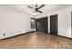Bedroom features hardwood flooring, a ceiling fan, closet and a black trim window at 552 Blue Rock Dr, Charlotte, NC 28213