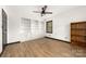 Bright bedroom featuring built-in shelving, a ceiling fan, and wood-look floors at 552 Blue Rock Dr, Charlotte, NC 28213