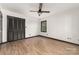 This bedroom features a ceiling fan, wood floors, and a window to let in natural light at 552 Blue Rock Dr, Charlotte, NC 28213