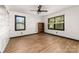 Bright bedroom features two windows with blinds and wood-look flooring at 552 Blue Rock Dr, Charlotte, NC 28213