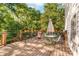 Relaxing deck area featuring outdoor seating with mature tree canopy at 552 Blue Rock Dr, Charlotte, NC 28213