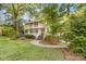 Charming two-story home featuring a double porch and inviting curb appeal surrounded by mature trees at 552 Blue Rock Dr, Charlotte, NC 28213