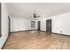 Large living room with hardwood flooring, a ceiling fan, windows and doors at 552 Blue Rock Dr, Charlotte, NC 28213