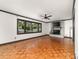Comfortable living room featuring hardwood floors, fireplace, and large windows providing natural light and scenic views at 552 Blue Rock Dr, Charlotte, NC 28213